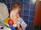 I swear that we did not pose her like this. She picked up the magazine while she was on the toilet.