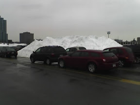 [Big pile of snow with cars.]