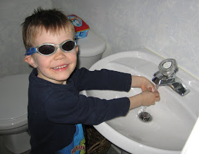 BigE with sunglasses on washing his hands
