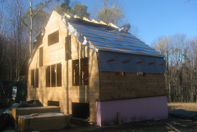 Up the back of the house with sheathing, wrap, foam and strapping.