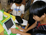 8 year old or so taiwanese boy starting to hack Python on the OLPC... impressive!
