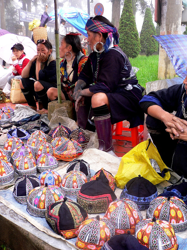 Hmong women, peddling embroidered caps, Sa Pa market