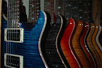 Up close & personal with the PRSi: Custom 24 (whale blue), Custom 24 (gray black), Custom 24 (cherry sunburst), Custom 24 (violin amber burst), Custom 22 semi-hollow (tobacco sunburst), 513 Mahogany (vintage natural), Custom 22 (vintage yellow); McCarty Rosewood (natural), Singlecut (black sunburst)