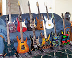 My Ibanez collection as of Dec 2000... L to R back: USRG30-TP USA Custom, RG1200-TR Prestige, Jem7-DBK, RG6-CST J-Custom, Jem7-VWH; L to R front: RG3120-TW Prestige, RG7CT-VV Prestige, UV777-BK Universe, RG-ART J-Custom, JPM90-HAM, JPM100-P1